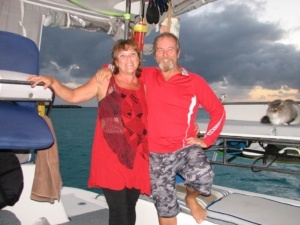 Alison and Andre Stroebel stand in the cockpit of their catamaran, Turquoise Turtle